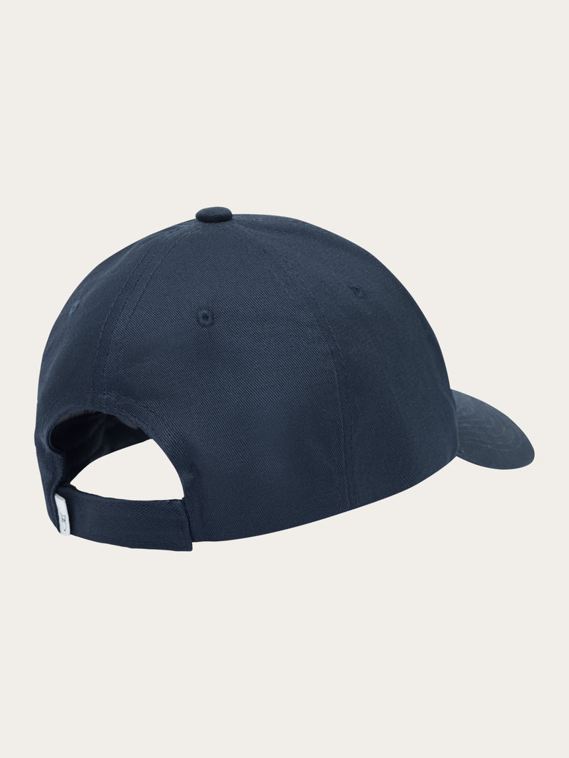 KnowledgeCotton Apparel - UNI Twill baseball cap with siliconebadge Caps 1001 Total Eclipse