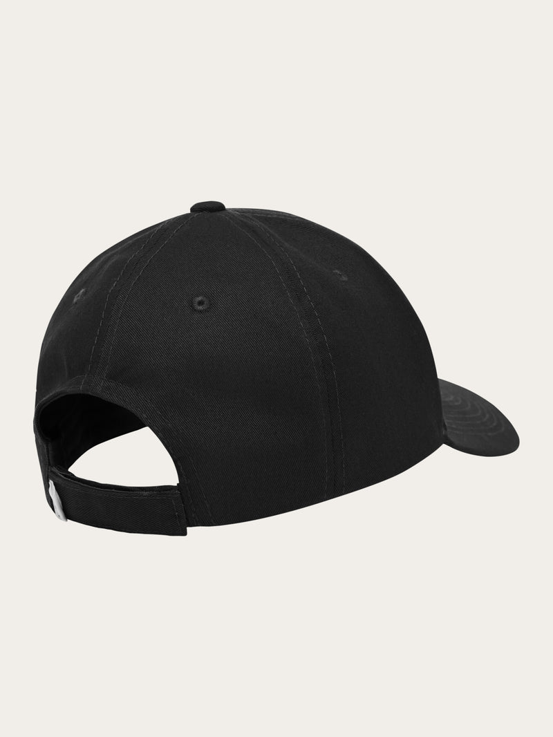 KnowledgeCotton Apparel - UNI Twill baseball cap with siliconebadge Caps 1300 Black Jet